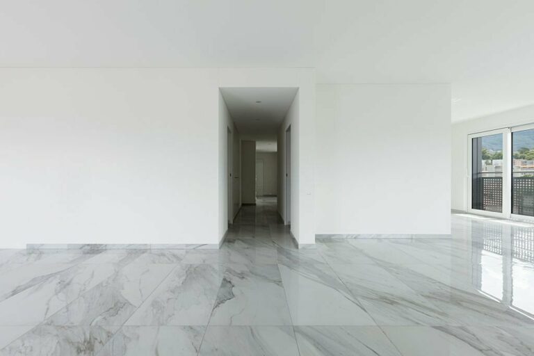 Interior of empty apartment, wide room with marble floor