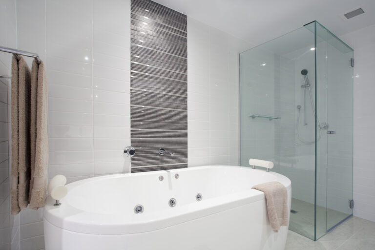 Stylish clean bathroom with shower and bath tub